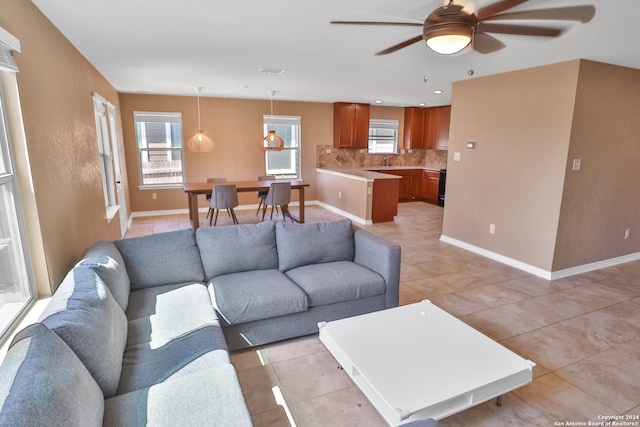 living room with light tile patterned floors and ceiling fan