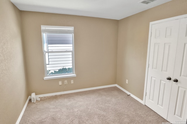 empty room with light colored carpet