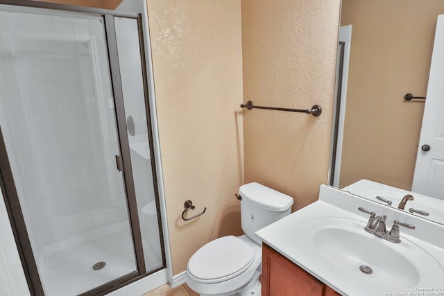 bathroom featuring vanity, toilet, and an enclosed shower