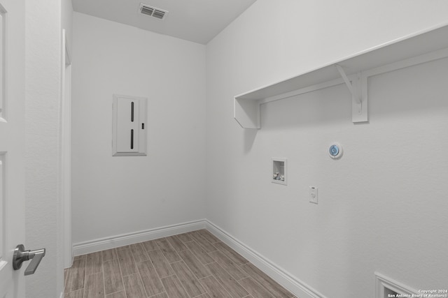 washroom with hookup for a washing machine and light hardwood / wood-style floors