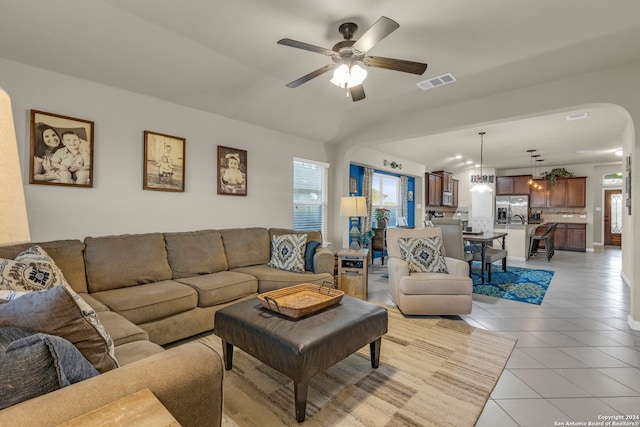 tiled living room with ceiling fan and a wealth of natural light