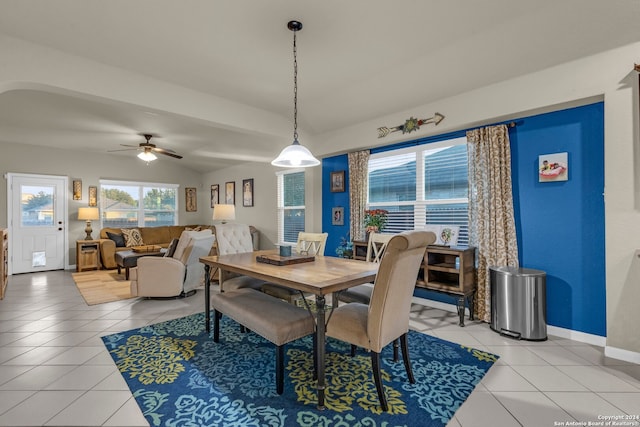 dining space featuring tile patterned floors, vaulted ceiling, and ceiling fan