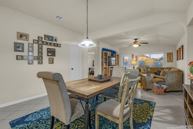 dining room with light tile patterned floors, vaulted ceiling, and ceiling fan