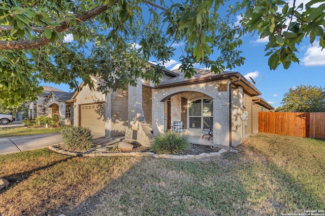 mediterranean / spanish house featuring a front lawn and a garage