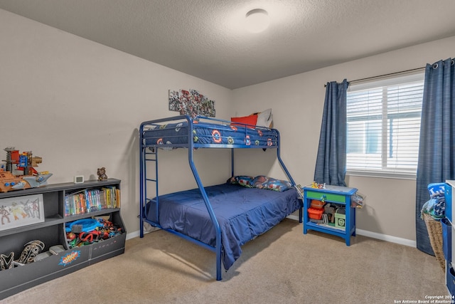 bedroom featuring a textured ceiling and carpet floors