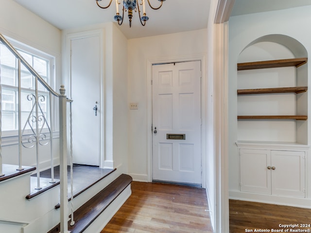 entryway featuring a chandelier and light hardwood / wood-style floors