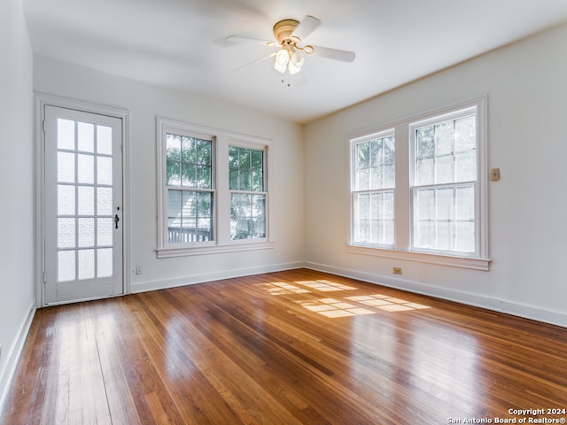 unfurnished room with ceiling fan and hardwood / wood-style flooring