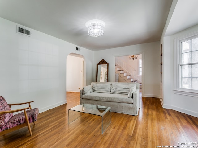 living room featuring a notable chandelier and wood-type flooring