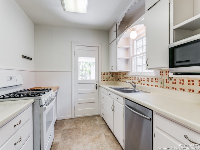 kitchen with white cabinetry, a healthy amount of sunlight, appliances with stainless steel finishes, and sink