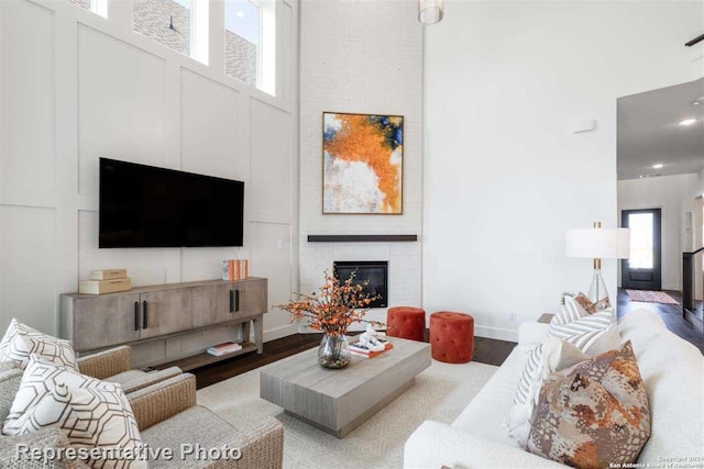 living room featuring light hardwood / wood-style floors and a brick fireplace