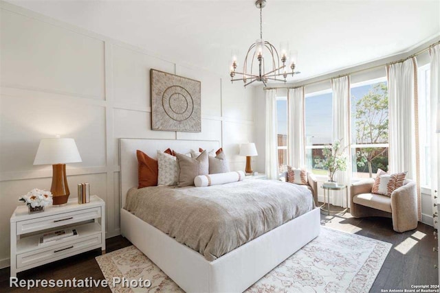 bedroom featuring dark hardwood / wood-style flooring and a chandelier