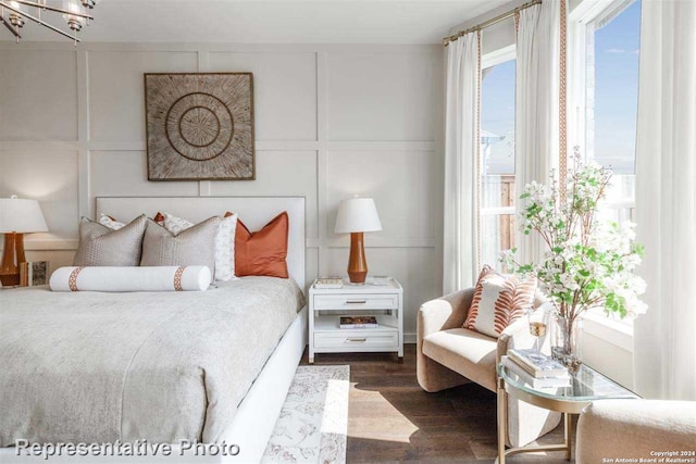 bedroom featuring a chandelier and dark hardwood / wood-style flooring