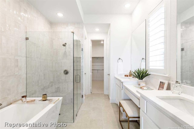 bathroom with separate shower and tub, tile patterned floors, and vanity