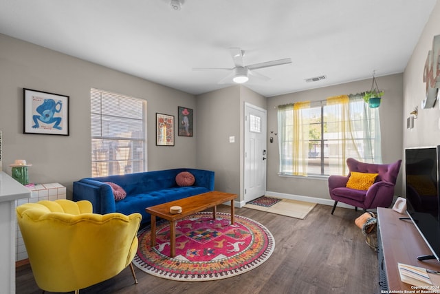 living room featuring hardwood / wood-style floors and ceiling fan