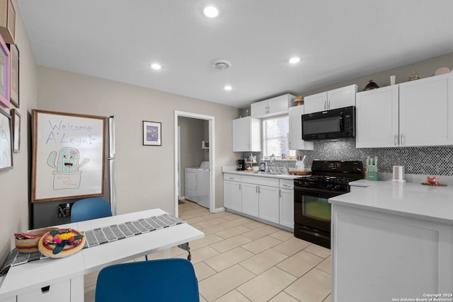 kitchen with backsplash, white cabinetry, separate washer and dryer, black appliances, and sink