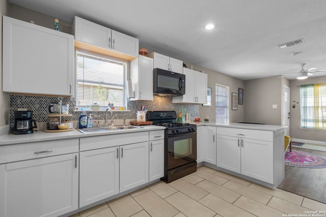 kitchen with kitchen peninsula, sink, black appliances, white cabinets, and ceiling fan