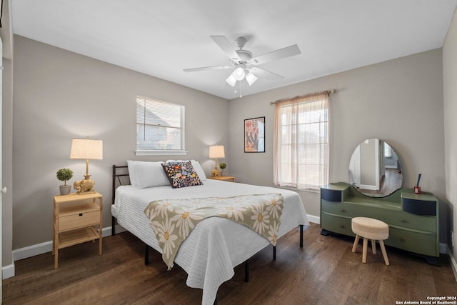 bedroom with dark hardwood / wood-style floors and ceiling fan