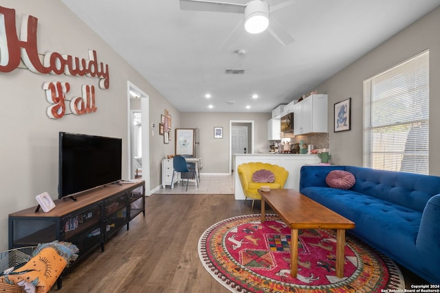 living room featuring dark hardwood / wood-style floors and ceiling fan