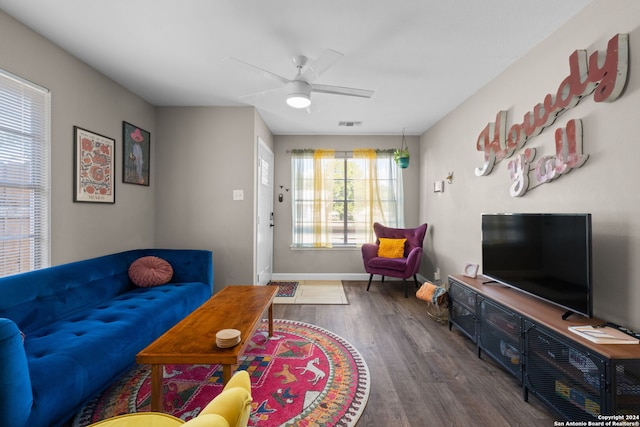 living room with ceiling fan and dark hardwood / wood-style floors