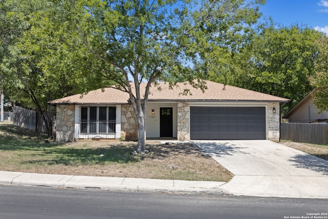 single story home featuring a front yard and a garage