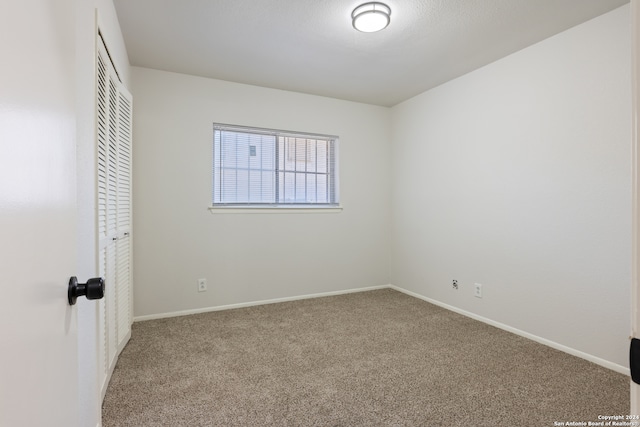 unfurnished bedroom featuring a closet and carpet