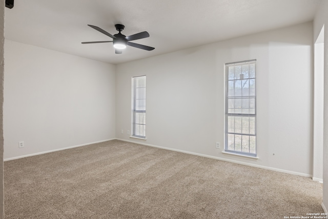 carpeted empty room featuring ceiling fan