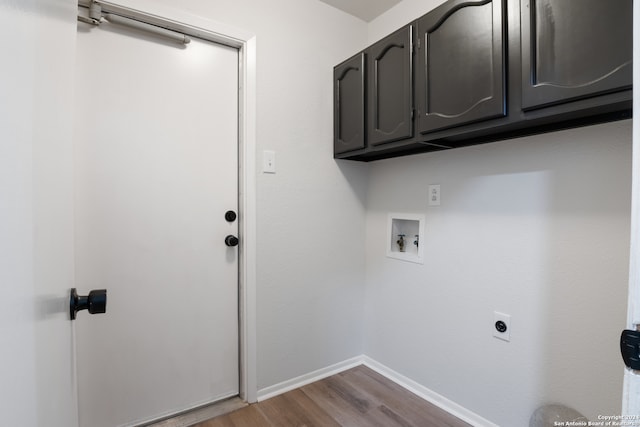 laundry area with electric dryer hookup, wood-type flooring, washer hookup, and cabinets