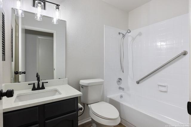 full bathroom with toilet, vanity, and washtub / shower combination