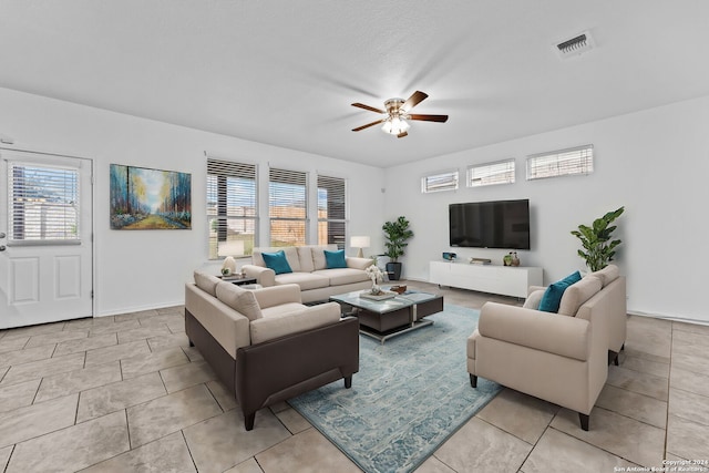 living room featuring light tile patterned floors and ceiling fan