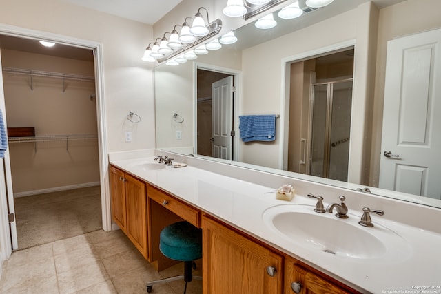 bathroom with vanity, walk in shower, and tile patterned floors