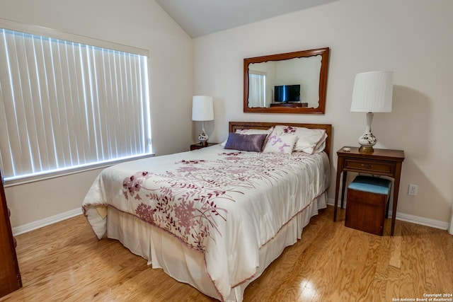 30 Wildwood Dr Unit 173, Georgetown, TX 78643 - bedroom featuring light wood finished floors, lofted ceiling, and baseboards