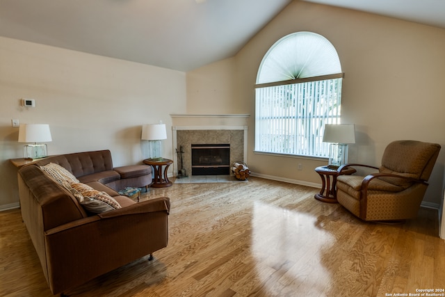 living room featuring hardwood / wood-style flooring and vaulted ceiling