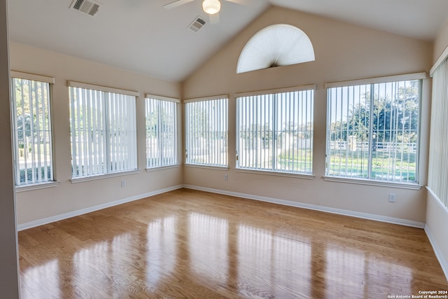 unfurnished sunroom with vaulted ceiling and ceiling fan