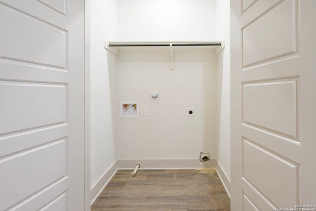 clothes washing area with hookup for an electric dryer, gas dryer hookup, dark wood-type flooring, and hookup for a washing machine