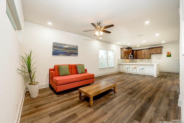 living room featuring dark hardwood / wood-style floors and ceiling fan