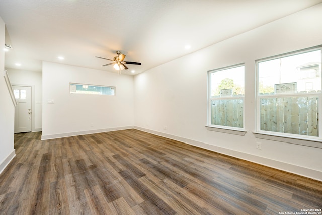 empty room with dark hardwood / wood-style floors and ceiling fan