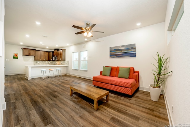 living room featuring dark hardwood / wood-style floors and ceiling fan