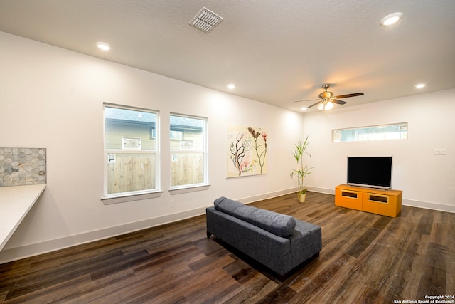 living room with dark hardwood / wood-style flooring and ceiling fan