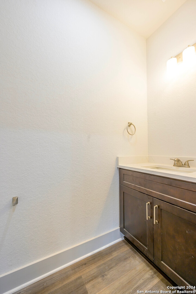 bathroom with vanity and hardwood / wood-style flooring