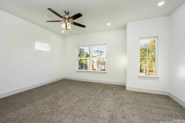 carpeted empty room featuring ceiling fan