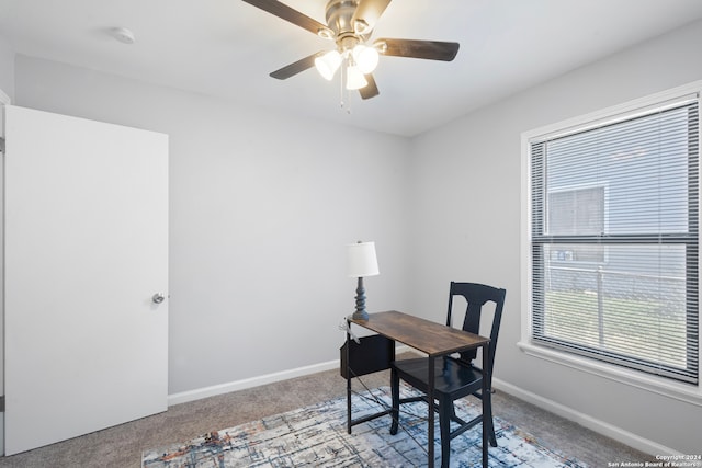 carpeted office featuring ceiling fan