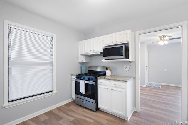 kitchen with white cabinetry, ceiling fan, appliances with stainless steel finishes, and light wood-type flooring