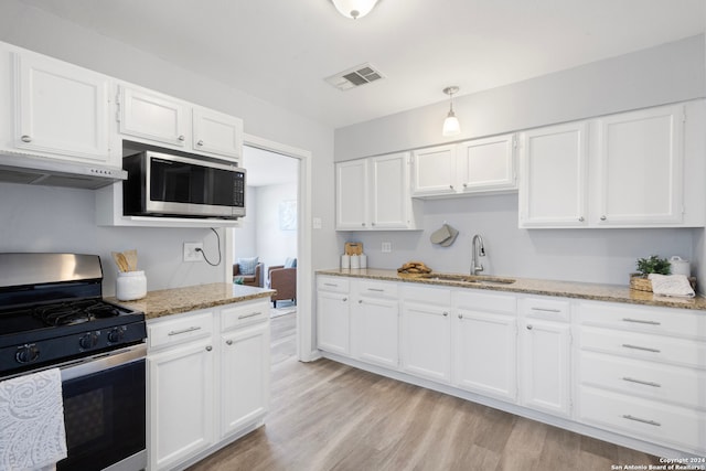 kitchen with light hardwood / wood-style flooring, stainless steel appliances, ventilation hood, sink, and white cabinets