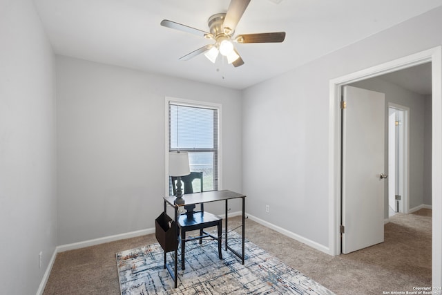 carpeted home office with ceiling fan