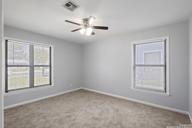 carpeted empty room featuring ceiling fan