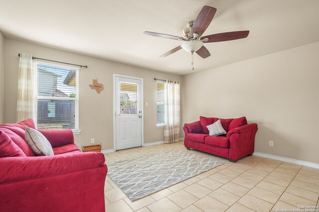 tiled living room with ceiling fan