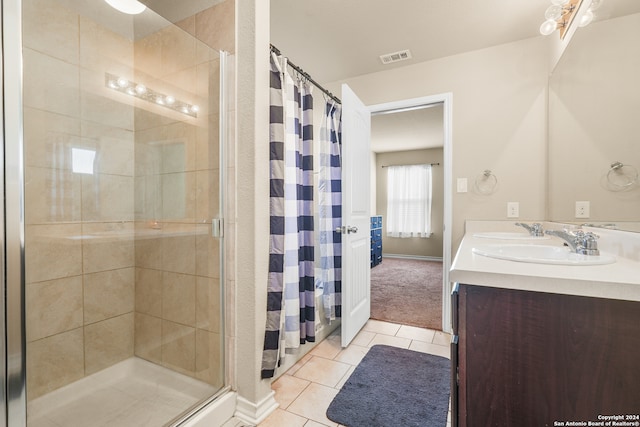 bathroom featuring vanity, walk in shower, and tile patterned flooring