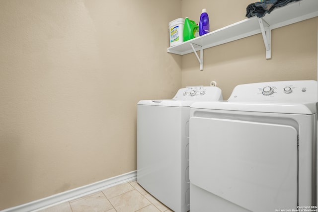 washroom featuring washing machine and clothes dryer and light tile patterned floors