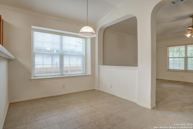 unfurnished dining area featuring crown molding, ceiling fan, light tile patterned floors, and plenty of natural light