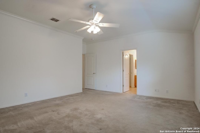 spare room featuring ceiling fan, light carpet, ornamental molding, and vaulted ceiling